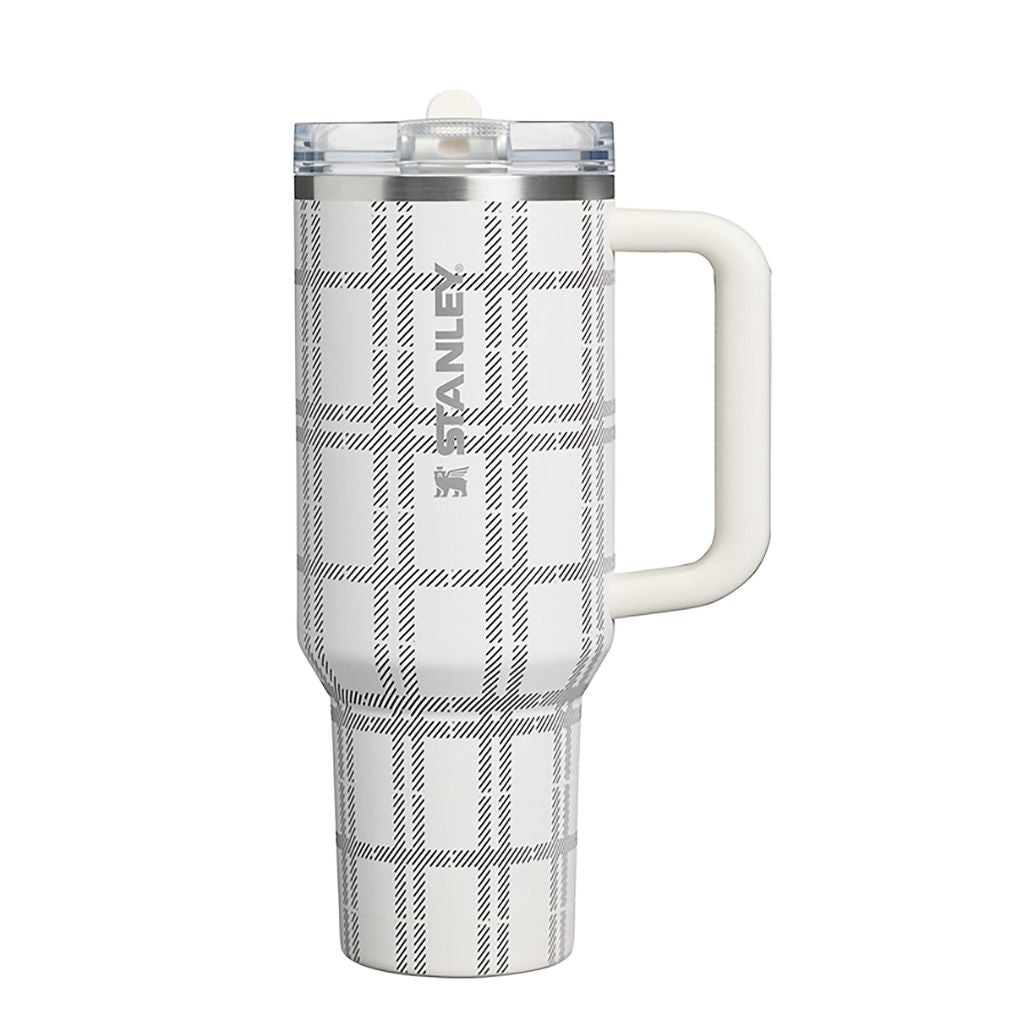 Stanley Salt Plaid tumbler featuring an ivory-white finish, black and gray windowpane plaid pattern with diagonal hatching, matching cream handle, clear lid, and silver Stanley logo