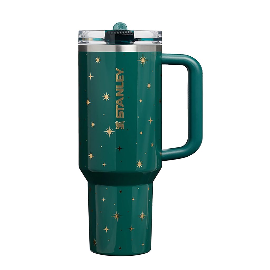 Stanley Shadow Green Night Sky tumbler featuring deep emerald teal-green finish, scattered metallic gold celestial stars and starbursts, matching green handle, clear lid, and gold Stanley logo
