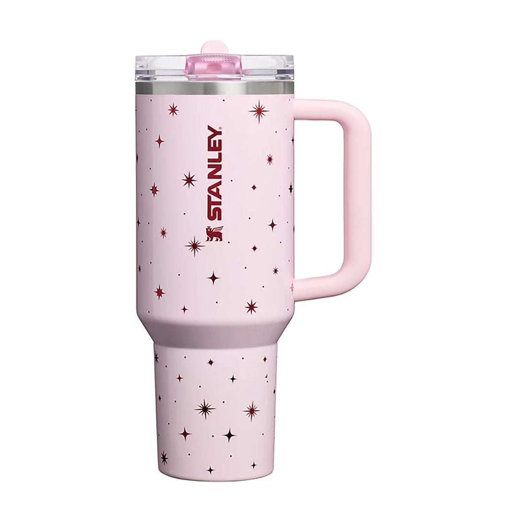 Stanley Soft Pink Night Sky tumbler featuring pastel blush pink finish, burgundy celestial stars and starbursts, matching pink handle, clear lid, and dark red Stanley logo