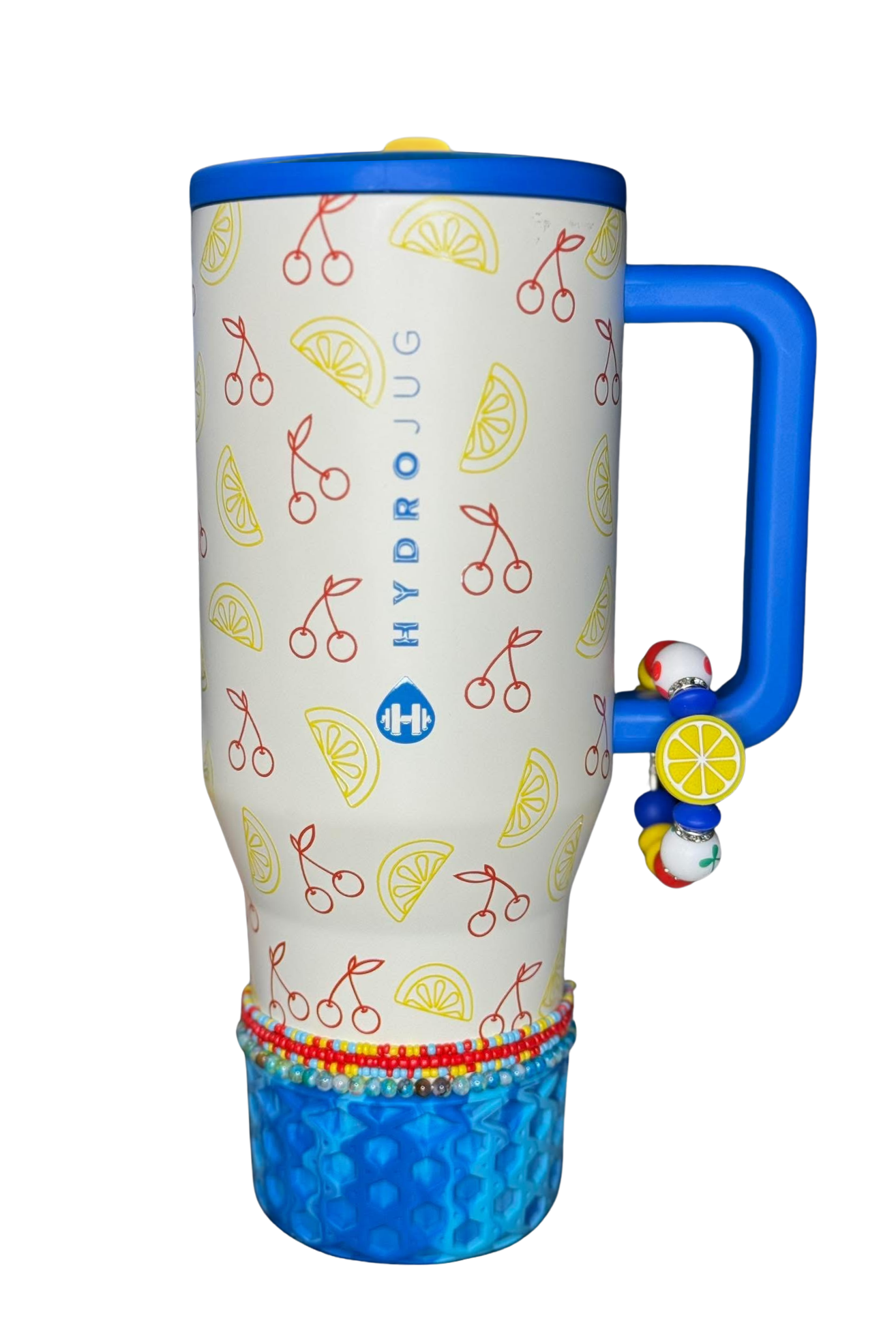 HydroJug Zesty Cherry tumbler with blue silicone boot, cherry and lemon graphics, matching tumbler charm, bracelet, straw topper, and coordinated fruit-themed accessories.