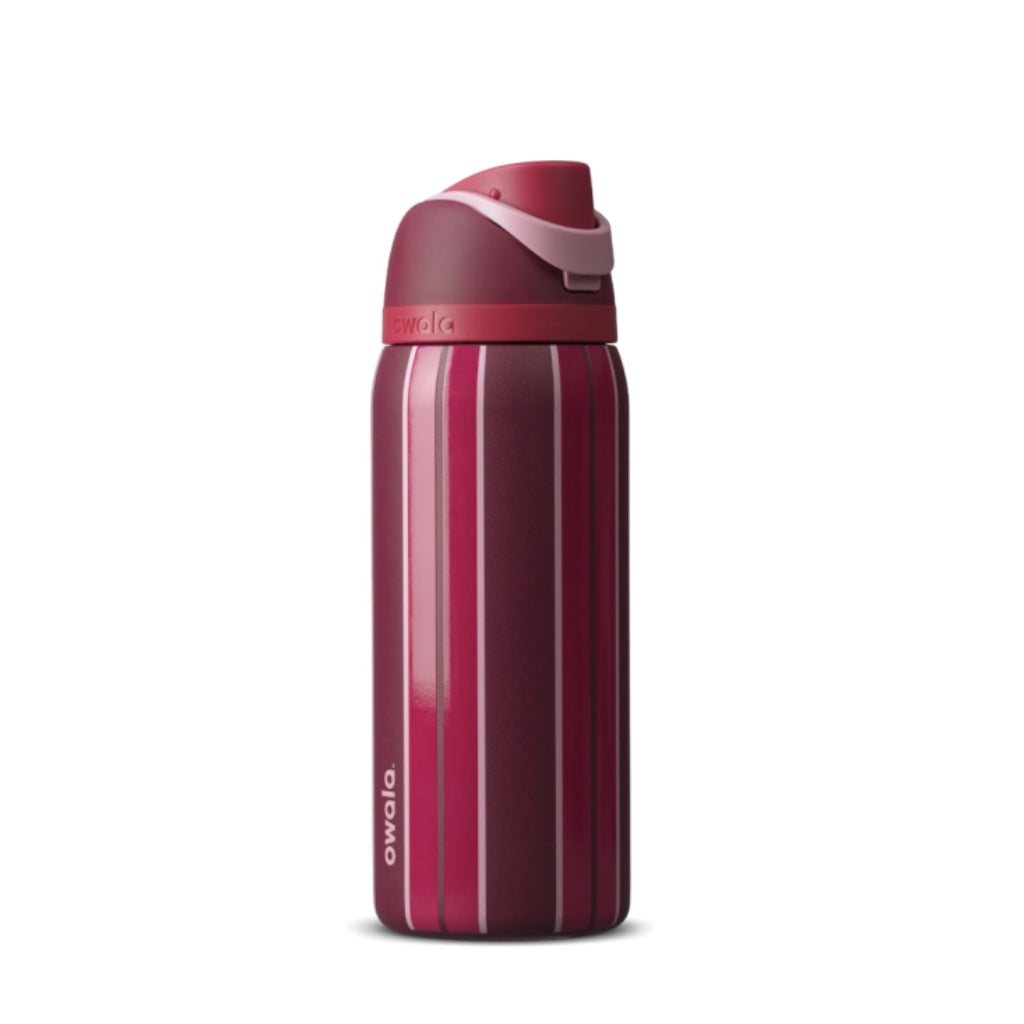 Owala Punchline FreeSip bottle featuring deep burgundy and berry pink vertical stripes with a dark wine-colored lid, raspberry band, and pale pink carry handle.