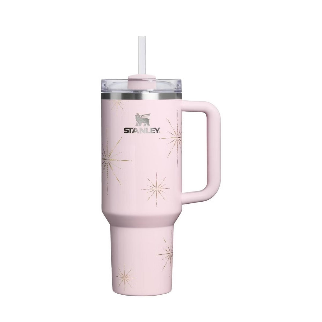 Stanley Flamingo Winter Radiance light pink tumbler with metallic gold starbursts, matching pink handle and clear lid