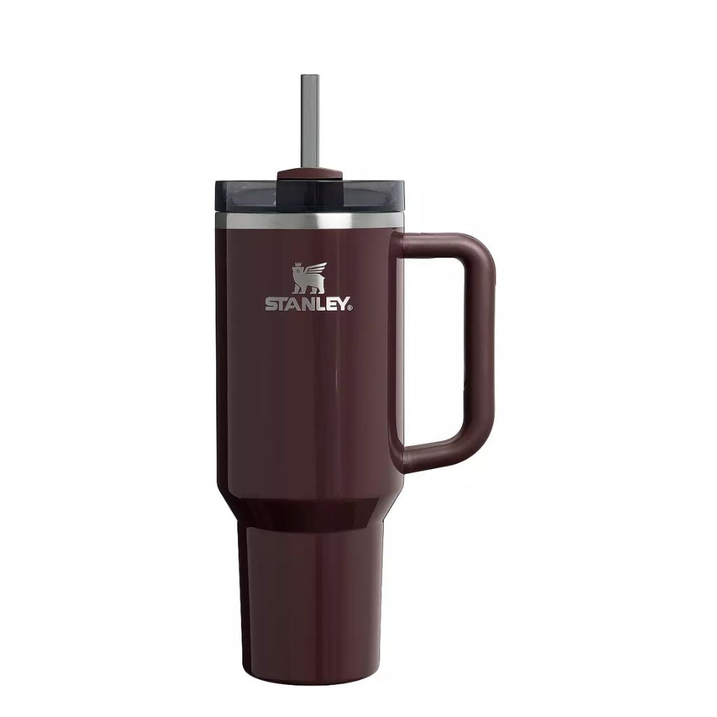 Stanley Mahogany Gloss tumbler featuring a deep glossy reddish-brown finish with burgundy and plum undertones, matching mahogany handle, smoky charcoal lid, dark straw, silver Stanley logo, and stainless steel rim.