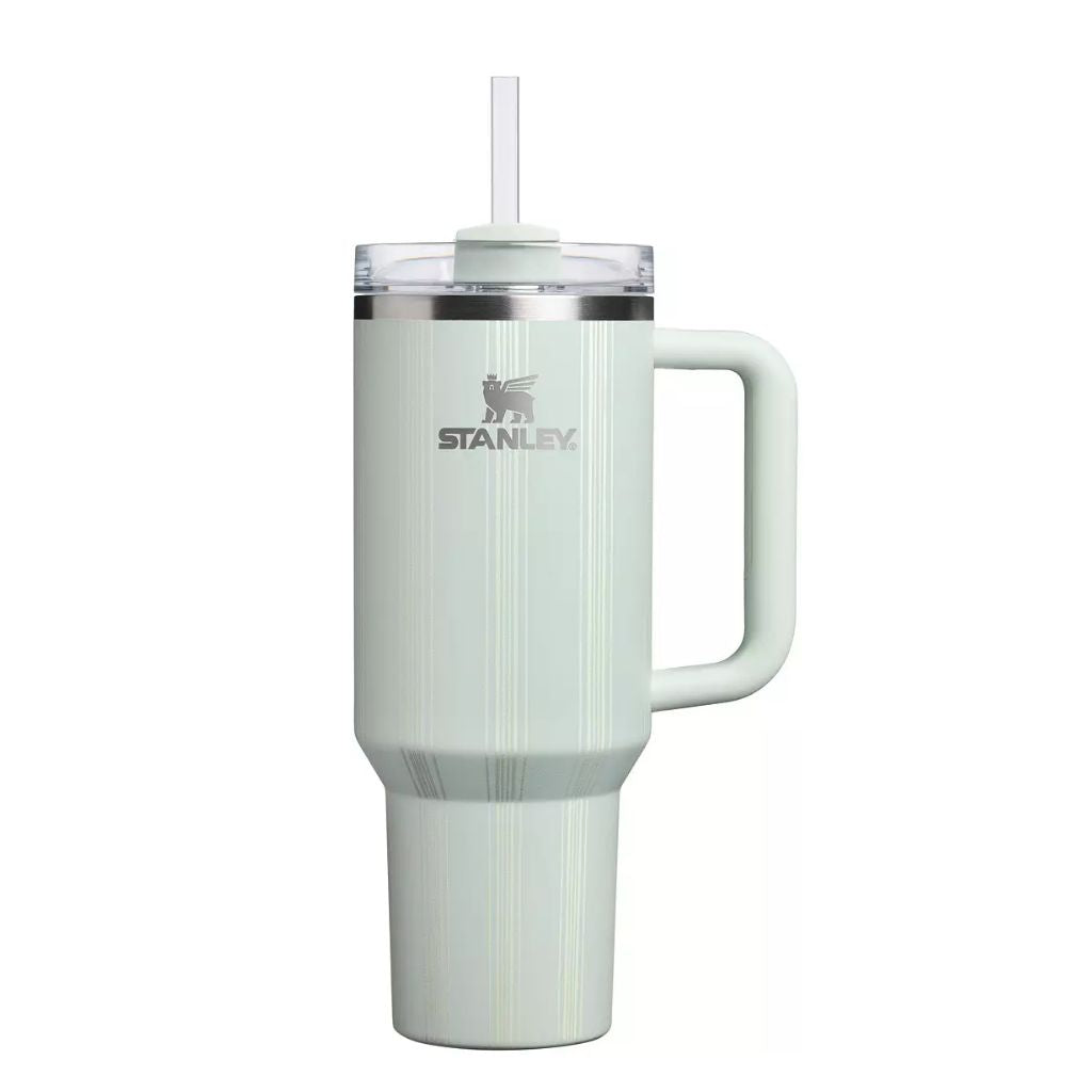 Stanley Mist Picnic Stripe tumbler in pale mint green with delicate vertical pinstripes, coordinating mint handle and straw topper, clear lid, silver Stanley logo, and stainless steel rim.