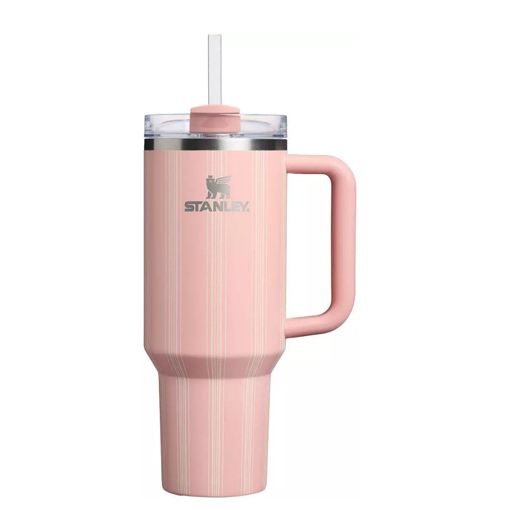 Stanley Peach Rose Picnic Stripe tumbler featuring a soft peachy blush-pink finish with delicate ivory and champagne vertical pinstripes, matching pink handle and straw topper, clear lid, silver Stanley logo, and stainless steel rim.