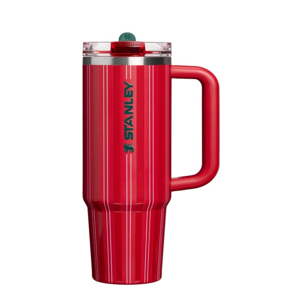 Stanley Rouge Holiday Stripe tumbler featuring bright cherry-red finish, tonal red vertical stripes, thin ivory pinstripes, dark forest-green Stanley logo, matching red handle, clear lid, and green lid accent.