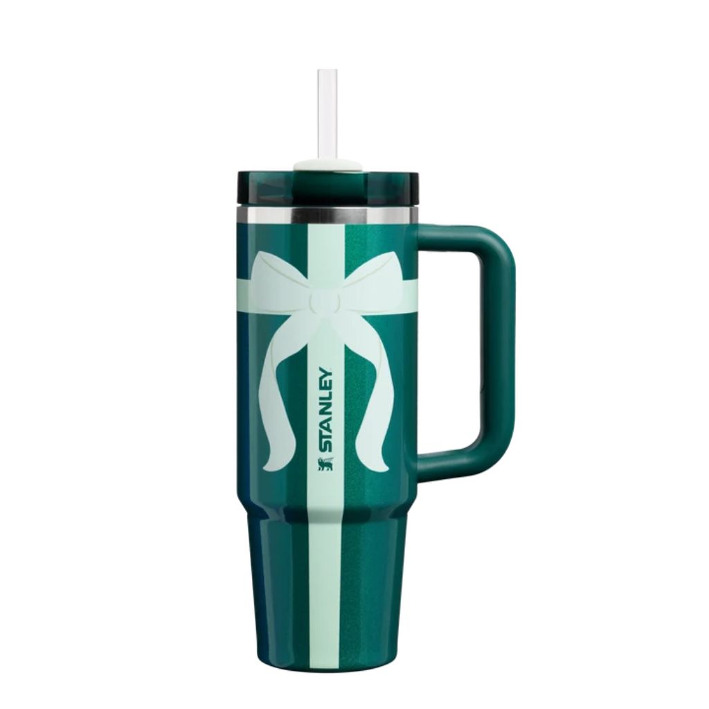 Stanley Shadow Green Ribbon tumbler featuring deep emerald-teal green finish, oversized pale mint gift-wrap bow with flowing ribbon tails, vertical mint ribbon stripe, matching dark green handle, translucent green lid, and white straw.